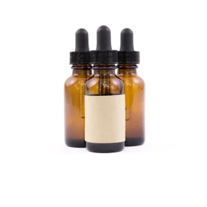 Three amber dropper bottles, one with a blank label